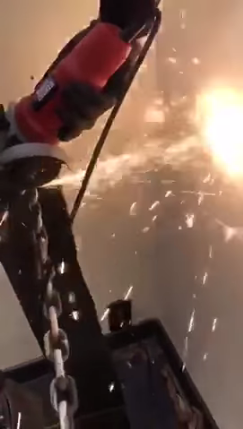 Angle Grinder cutting a steel chain - Video Screenshot.png