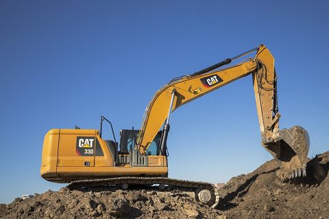 Caterpillar 330 excavator on a pile of dirt.jpg