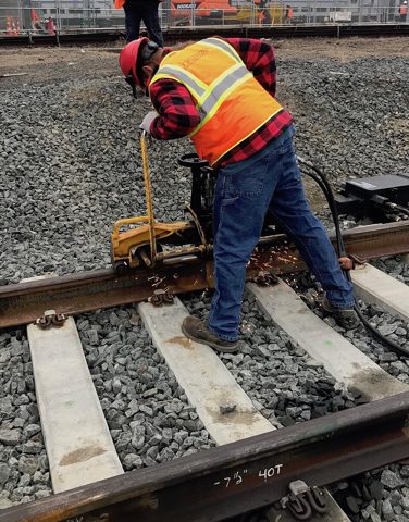 Grinding thermite welded track to create smooth continuous rail. 04-12-19 (46729514965).jpg