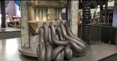 Abrasive Flow Machining Machine: Machine that deburrs and polishes internal passages by extruding a viscous abrasive putty