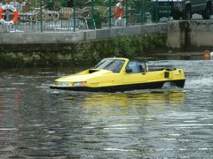 Amphibious Car: Vehicle capable of operating on both land and water: a sealed buoyant hull body carries a road drivetrain