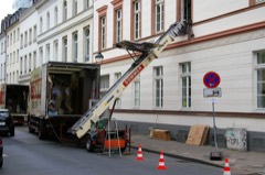 Moving Truck: Box truck with a loading ramp used for household furniture relocation