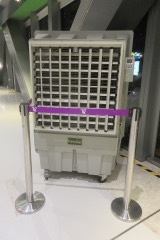 Portable Evaporative Cooler: A wheeled swamp cooler that draws air through a water-soaked cellulose pad and a blower