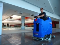 Ride-On Scrubber Dryer: Operator-seated floor cleaning and drying machine with rotating brush or pad scrub deck